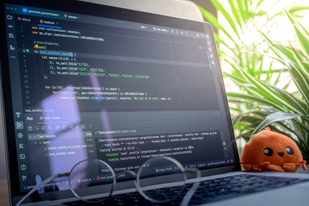 laptop-screen-displaying-code-with-glasses-and-plush-toy-7lzjmwexxnu